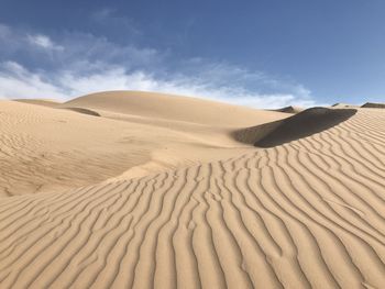 Sand dune in desert against sky