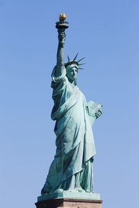 Low angle view of statue against blue sky