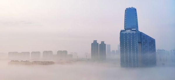 Modern buildings in city against sky