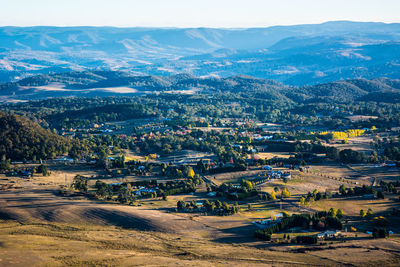 Aerial view of houses and mountains against sky