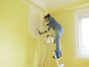 Side view of  woman working at home