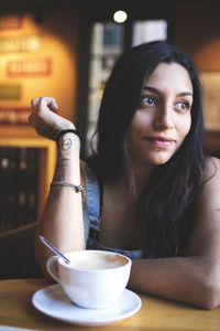 Portrait of young woman sitting at cafe