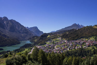 Scenic view of lake and mountains against clear sky