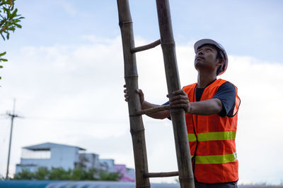 Low angle view of man standing against sky