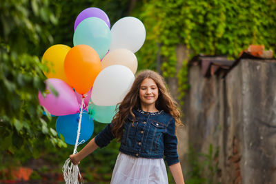 Portrait of a smiling young woman standing outdoors