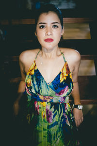 Portrait of woman standing against wall