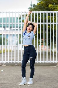 Full length of young woman exercising in park