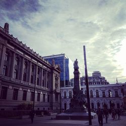 Low angle view of historical building against cloudy sky