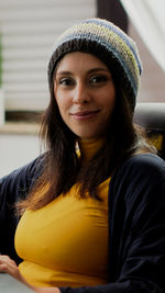 Portrait of smiling young woman wearing knit hat