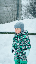 Cute boy in snow covered land