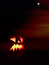 Close-up of illuminated pumpkin against black background