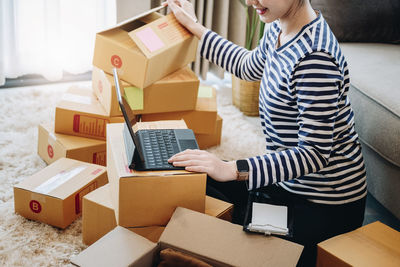 Midsection of woman using digital tablet