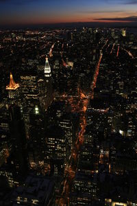 Aerial view of city lit up at night