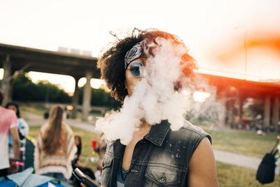 Close-up portrait of man smoking at music festival