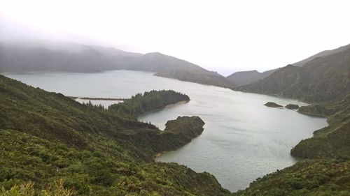 View of calm lake along lush foliage