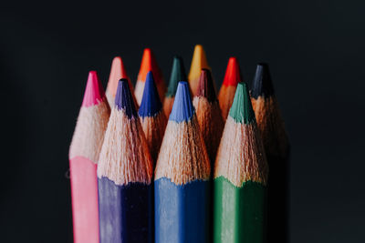 Close-up of colorful pencils against black background