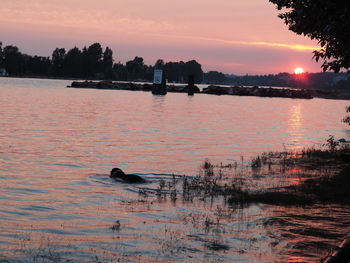 Scenic view of lake against sky during sunset