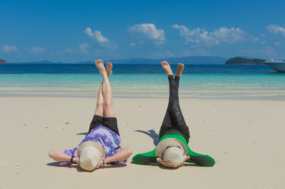 People on beach against sky