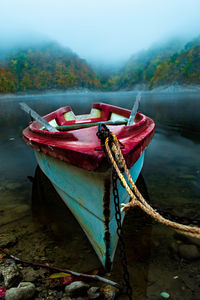 Boat moored on lake