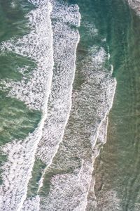 High angle view of water splashing in sea