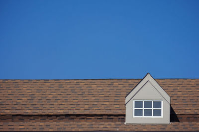 Low angle view of building against clear blue sky