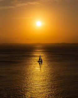 Scenic view of sea against orange sky during sunset