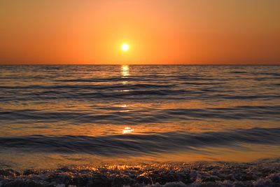 Scenic view of sea against romantic sky at sunset
