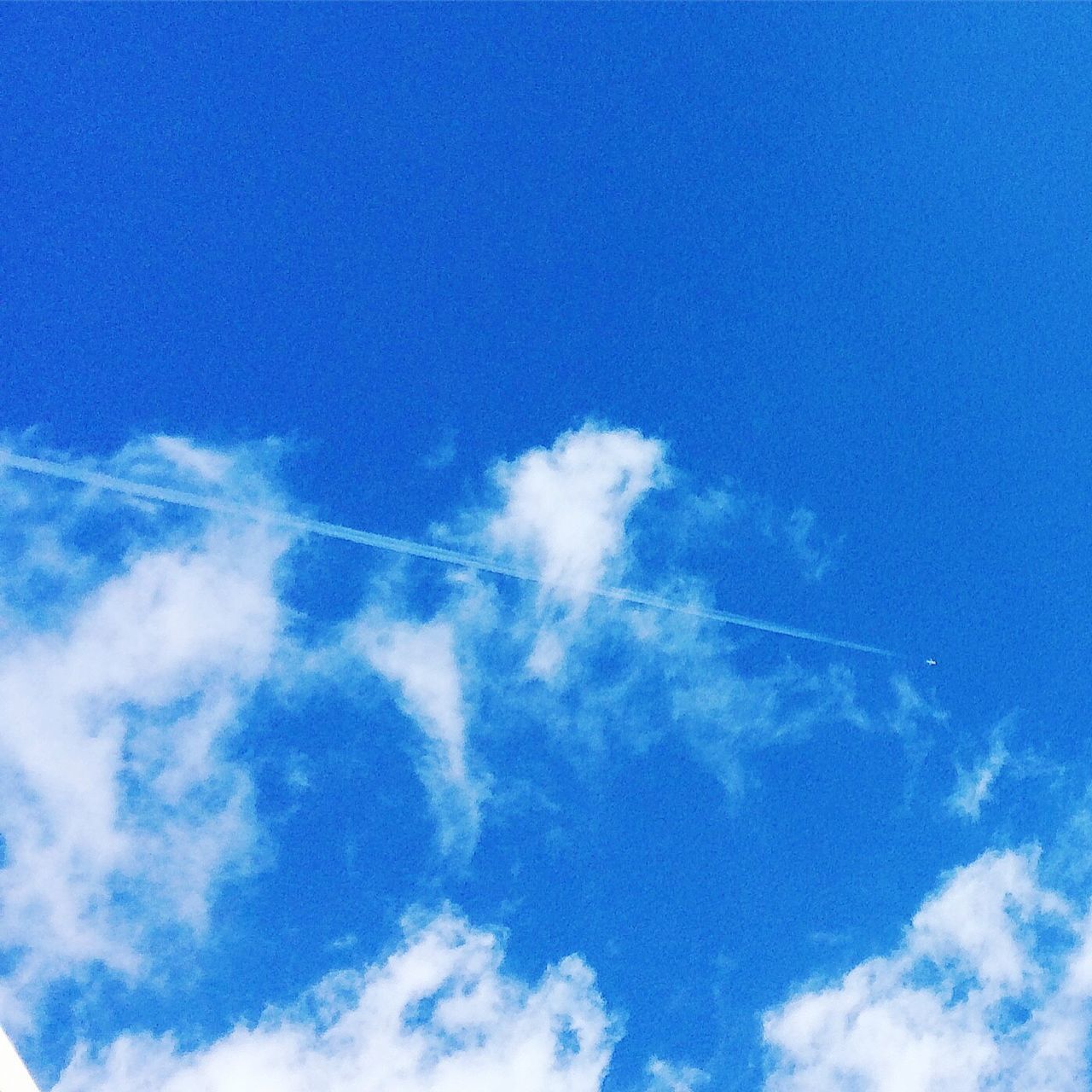 LOW ANGLE VIEW OF VAPOR TRAILS IN SKY