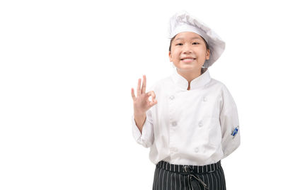 Portrait of a smiling young woman against white background