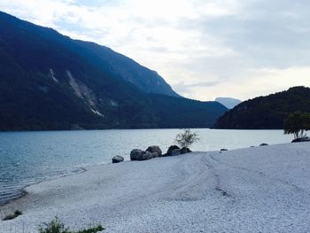 Scenic view of lake and mountains against sky