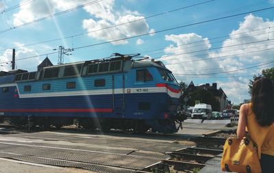 Train on railroad tracks against sky