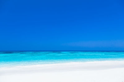 Scenic view of sea against clear blue sky