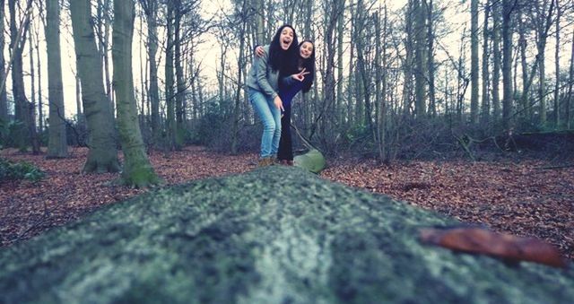 tree, lifestyles, leisure activity, forest, full length, casual clothing, young adult, person, standing, looking at camera, front view, portrait, nature, tranquility, tranquil scene, day, landscape, tree trunk