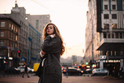 Young woman standing on city street