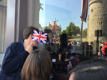 Rear view of people sitting at flags