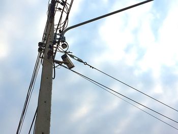 Low angle view of electricity pylon against sky
