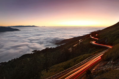 High angle view of light trails on road against sky during sunset