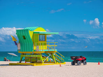 Scenic view of beach against blue sky