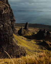 Old man of storr rock formations with golden light and dramatic sky on isle of skye scotland.