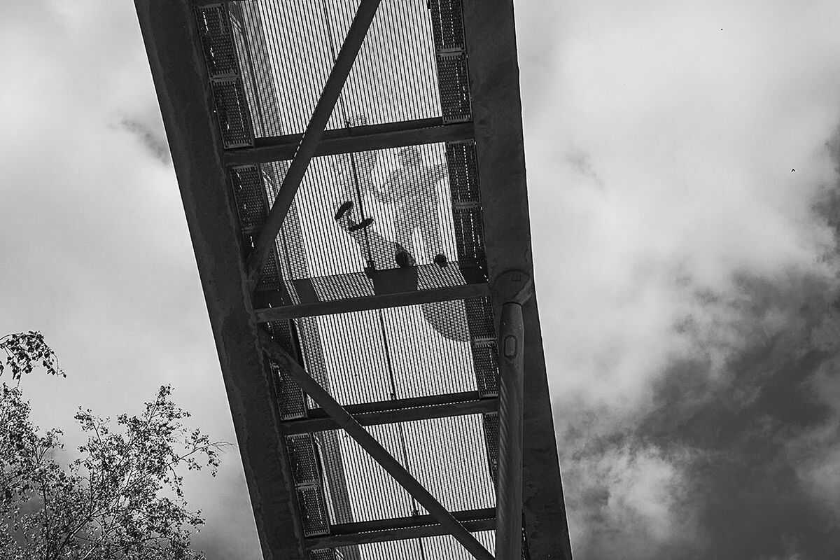 sky, low angle view, built structure, cloud - sky, architecture, cloudy, railing, cloud, metal, day, overcast, outdoors, silhouette, metallic, weather, connection, transportation, bridge - man made structure, no people, staircase
