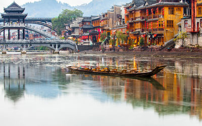 Bridge over river against buildings in city