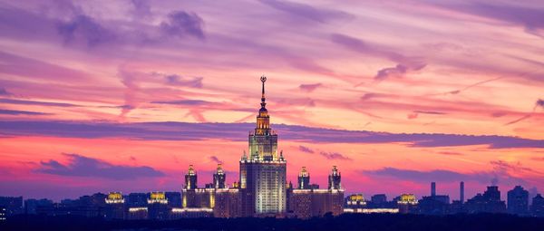 Landscape sunset panorama of illuminated moscow university under dramatic sky