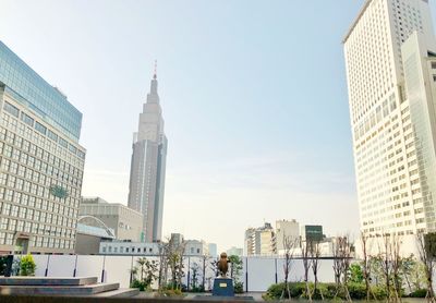 Low angle view of buildings in city against clear sky