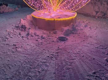 High angle view of illuminated container on wet land