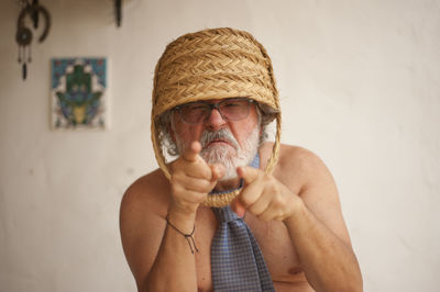 Portrait of man holding hat