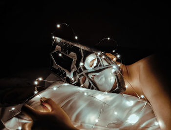 High angle view of hand on illuminated lighting equipment