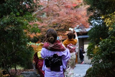 Rear view of people walking in park