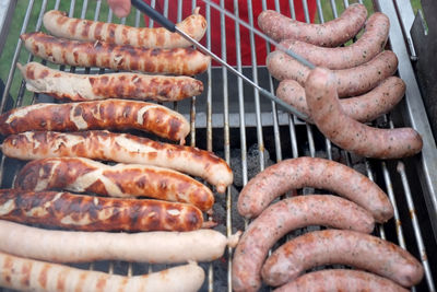 High angle view of sausages on barbeque grill