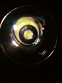 Close-up of illuminated electric lamp against black background