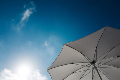 Low angle view of beach umbrella against sky during sunny day